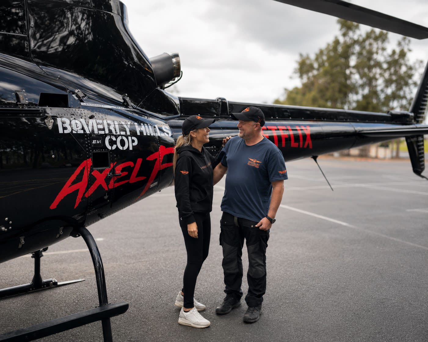 David Adamson and Jen Bewes beside the Beverly Hills Cop: Axel F picture helicopter