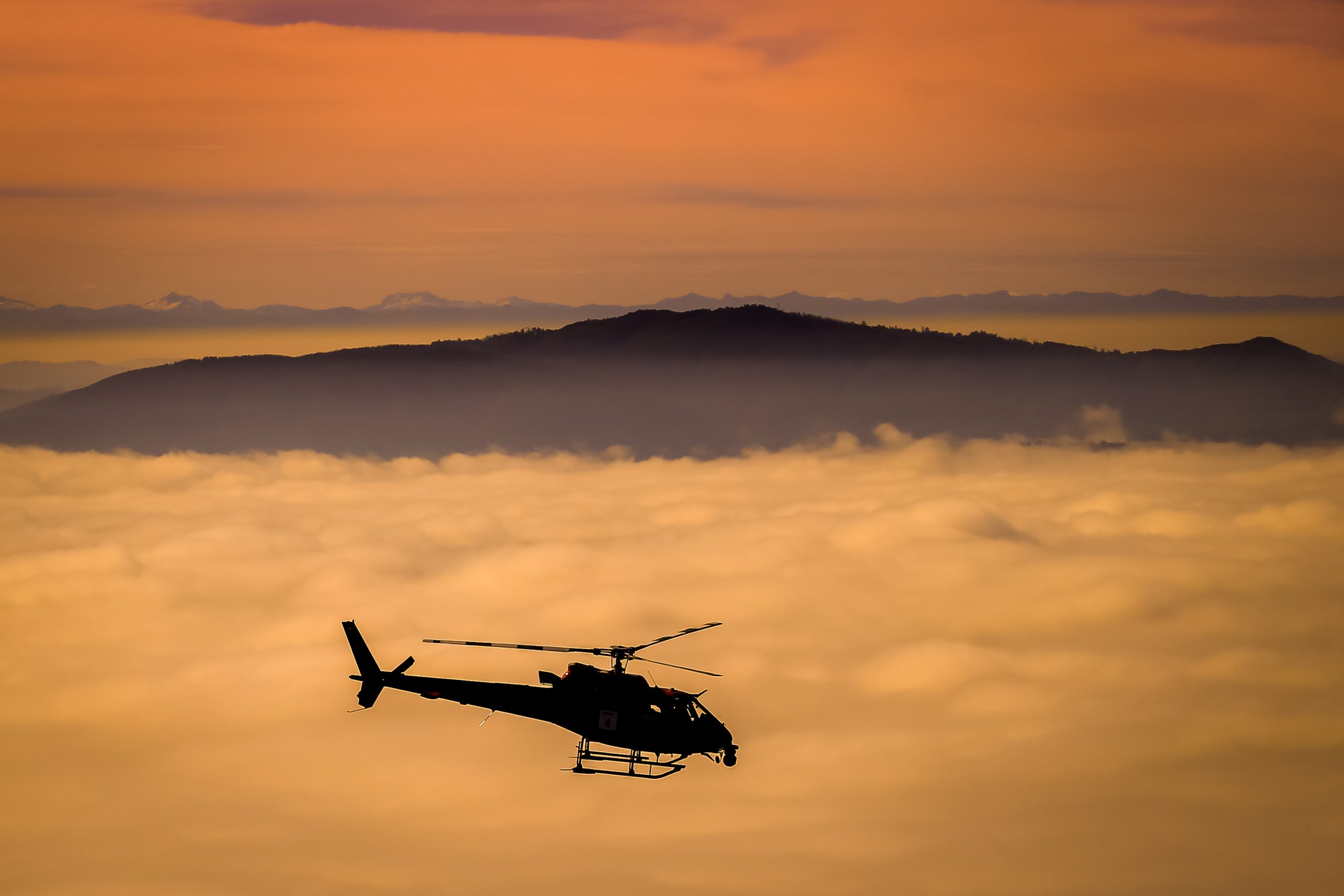 Film helicopter with gyro-stabilised camera system staged at sunset between takes